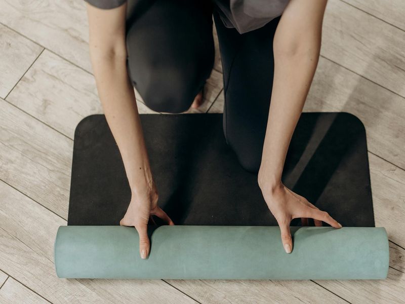 Close up of yoga equipment and a mat on wooden floor
