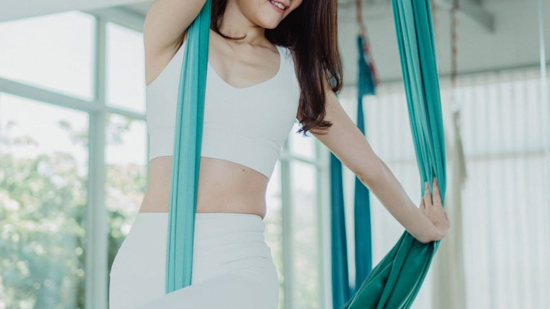 Serene woman practicing yoga in a bright modern studio